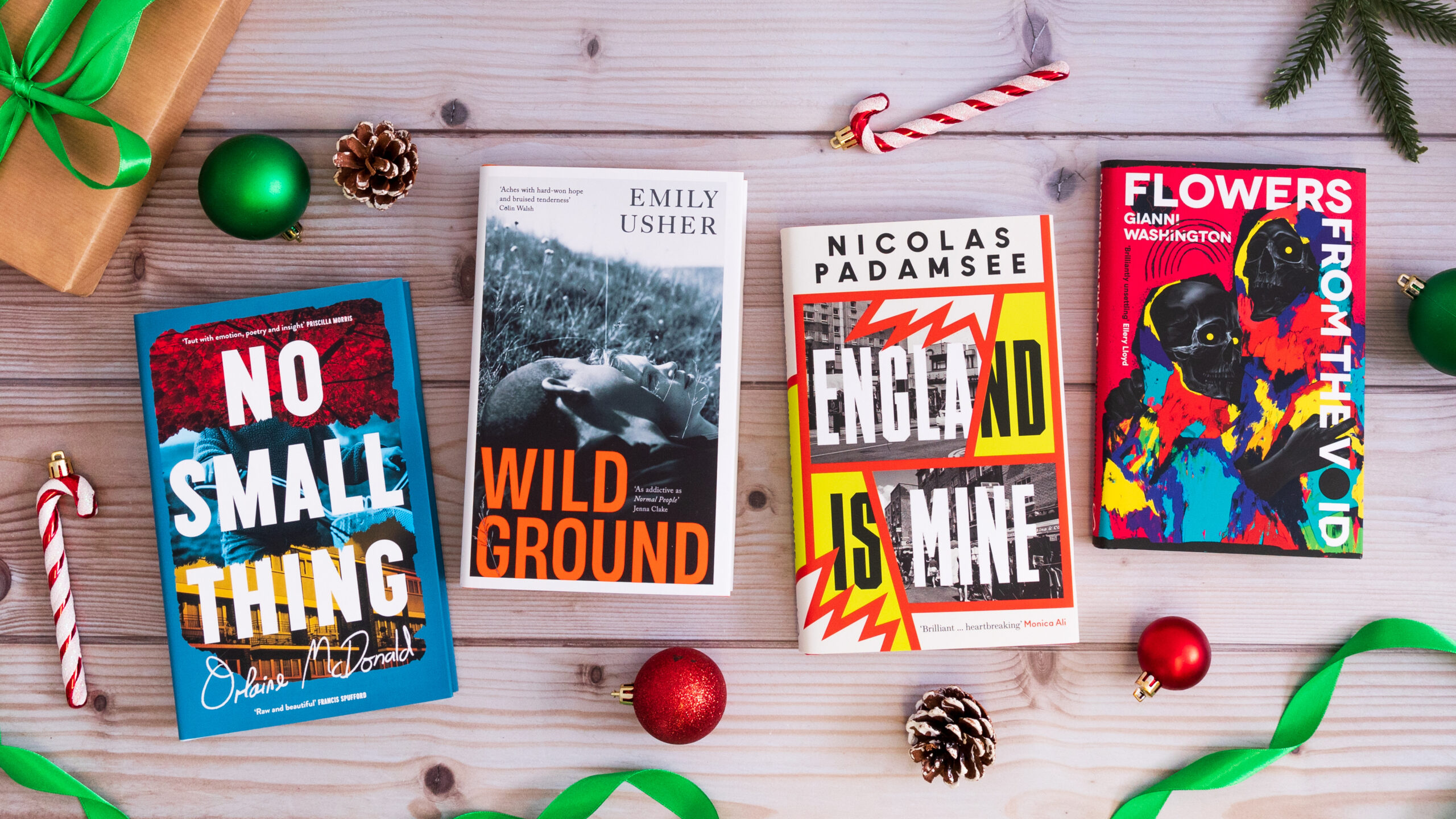 A top-down photograph featuring four Serpent's Tail books with Christmas decorations surrounding them. The books are: No Small Thing, England is Mind, Wild Ground and Flowers from the Void. 